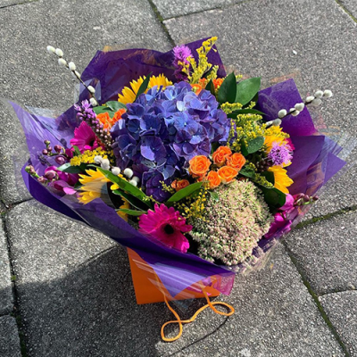 Florist choice bright handtied - A bright and bold handtied bouquet in a mix of vibrant colours and flowers by Floribunda Florist. hand delivered with care in and around Manchester. Although the flowers might be different the florist will choose only the freshest flowers in stock that day. (the flowers may vary from the picture due to seasonal availability)