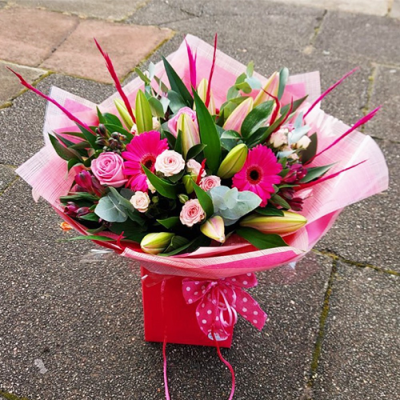 Let's Celebrate! - A bright handtied bouquet in vibrant pink flowers by Floribunda Florist. Hand delivered with care in and around Manchester.  (the flowers may vary from the picture due to seasonal availability)