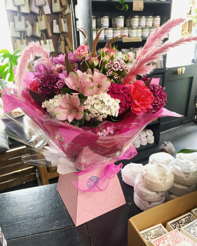 Ashleigh - A budding delight, complimented by greenery and presented in a gift box/bag. Beautiful flower bouquet hand delivered by the local florist.