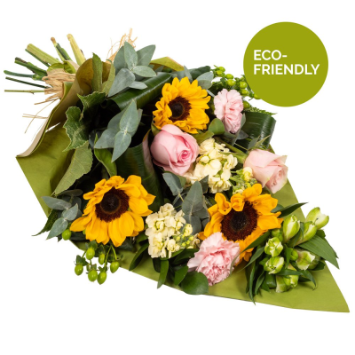 Day Break - Brighten the dullest of days with this glorious array of flowers. Amazing sunflowers with a complement of selected blooms... Bright and stunning swathed in a wrap friendly and natural.